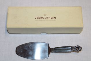 A Danish silver serving slice by Georg Jensen with fluted handle,