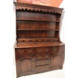 A Georgian-style oak farmhouse dresser with three drawers in the frieze and three central drawers