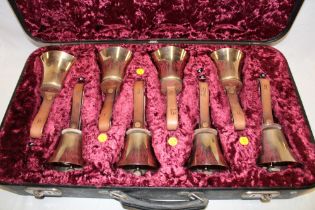 Three case sets of modern brass hand bells by The White Chapel Bell Foundry Co.