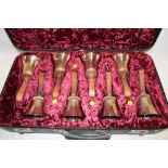 Three case sets of modern brass hand bells by The White Chapel Bell Foundry Co.