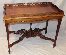 A reproduction mahogany tray-top rectangular occasional table with pierced gallery on square-shaped