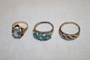 Three various 9ct gold dress rings including topaz etc. (11.