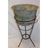 A 19th century iron circular tapered basin on wire-work stand,