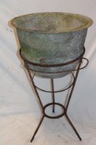 A 19th century iron circular tapered basin on wire-work stand,