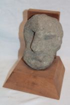 An ancient stone Celtic head with protruding nose and open mouth,