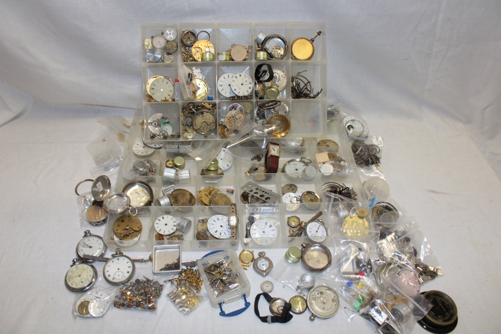 Various pocket watch parts including faces, part cases, movements,