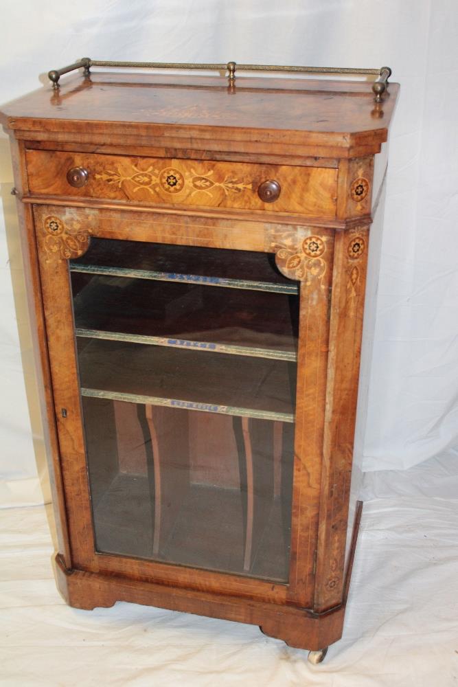 A Victorian inlaid burr walnut music cabinet with a single-drawer in the frieze and leather mounted