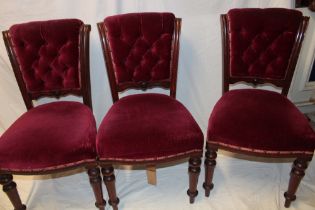 A set of four Victorian mahogany dining chairs with upholstered seats and backs on turned tapered