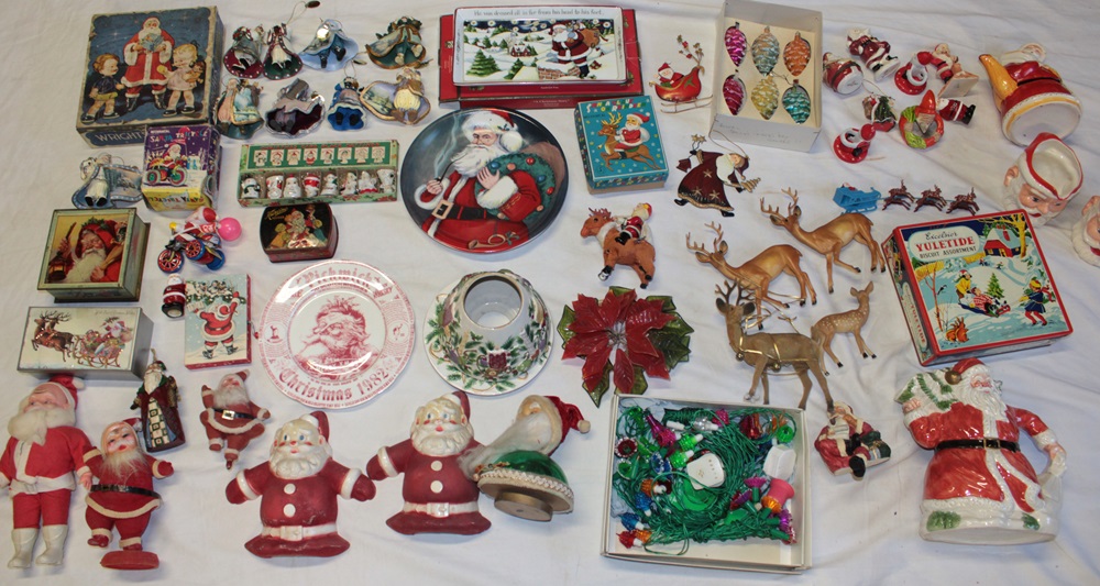 A selection of vintage Christmas decorations including Father Christmas figures, reindeer, tins,