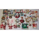 A selection of vintage Christmas decorations including Father Christmas figures, reindeer, tins,