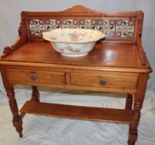 A Victorian polished pine wash-stand with two drawers in the frieze and ceramic tiled back on