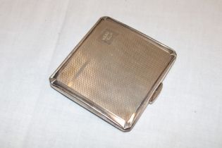 A silver rectangular cigarette case with engine turned decoration,