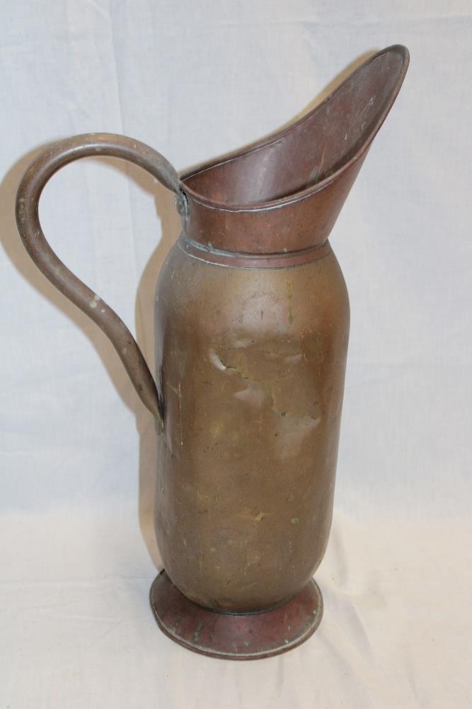An old copper and brass mounted cylindrical water jug,