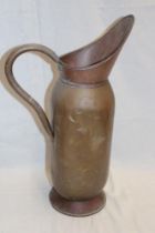 An old copper and brass mounted cylindrical water jug,