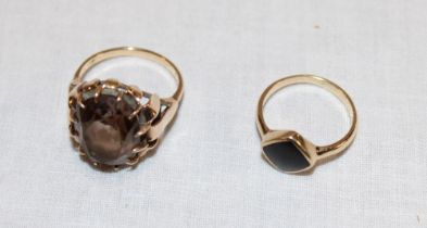 A 9ct gold dress ring set smoky quartz and one other 9ct gold dress ring set a black stone (7.