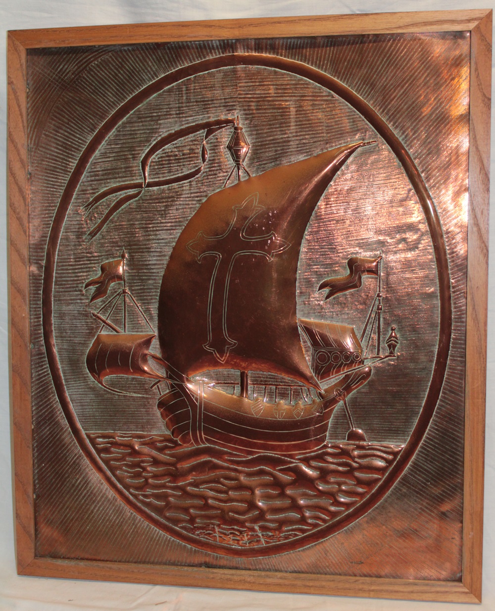 A Cornish copper rectangular plaque decorated in relief with Viking ships, 23½" x 19½",