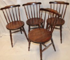 A set of four Ibex-style kitchen chairs with spindle backs and circular seats on turned legs