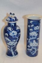 A late 19th century Chinese baluster-shaped vase with cover with blue and white blossom decoration