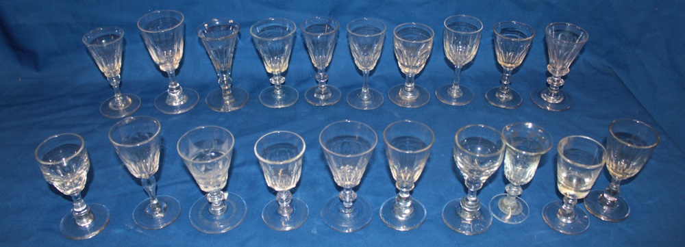 A selection of 18th and 19th century stemmed drinking glasses of similar form with tapered stems