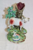 A 19th century Staffordshire pottery figure by Walton depicting a sheep and lamb below a tree trunk