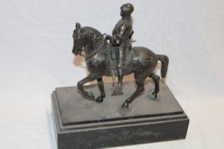 A bronzed spelter figure of a knight on horseback on slate rectangular base,