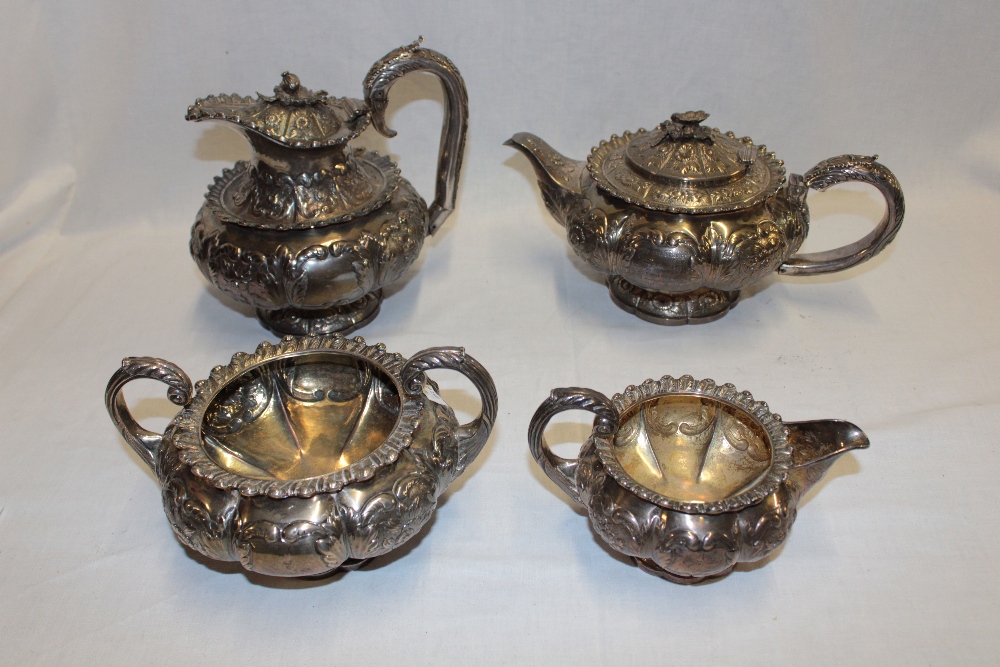 An unusual George IV silver tea and coffee set comprising circular pedestal coffee pot with