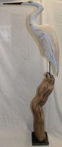 A Cornish carved wood figure of a heron on a stump by Geoffrey Bickley of St.