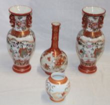 A pair of Japanese Kutani pottery baluster-shaped two-handled vases with painted bird and floral