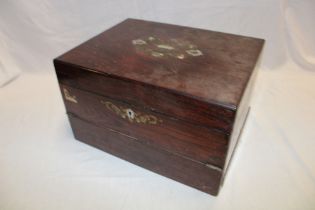 A Victorian inlaid rosewood rectangular writing slope with pigeon holes and drawers enclosed by a