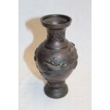 A 19th century Japanese bronze baluster-shaped vase decorated in relief with birds and flowers,