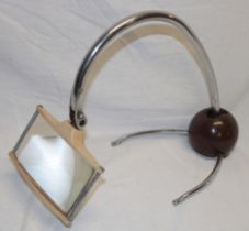 A 1930's chromium-plated and painted metal table magnifier with weighted base