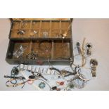 A jewellery box containing a quantity of various costume jewellery including earrings, necklaces,