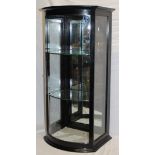 A 19th century ebonised commercial bow-fronted counter top display cabinet with glass shelves and