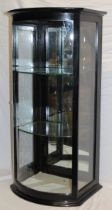 A 19th century ebonised commercial bow-fronted counter top display cabinet with glass shelves and