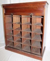A stained walnut Cornish clerk's bank of 24 pigeon holes enclosed by a brass mounted tambour