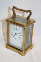 A French carriage clock with rectangular enamelled dial in brass traditional glazed case