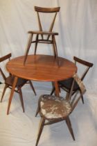 A 1960's Ercol pale elm circular dining table 35½" diameter (af) together with a set of four Ercol