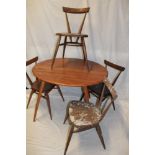 A 1960's Ercol pale elm circular dining table 35½" diameter (af) together with a set of four Ercol