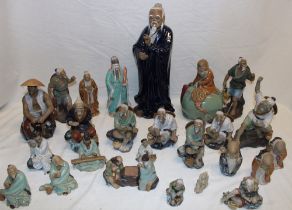 A selection of Eastern glazed terracotta figures of male characters including a 15" character in