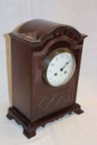 A good quality brass mounted mahogany arched mantel clock by Maple and Co.