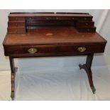 A reproduction mahogany ladies' writing table with numerous small drawers and inset leather writing