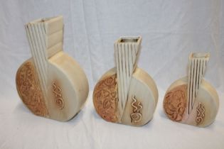 A set of three 1960's pottery Art Deco-style graduated vases with raised decoration,