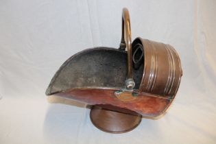 A Victorian copper traditional pedestal coal helmet with swing handle