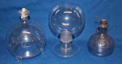 An unusual glass two-part stemmed display sphere on tapered pedestal,