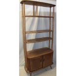 A 1960's Ercol pale elm "Giraffe" room divider with open shelves and base cupboard enclosed by two