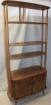 A 1960's Ercol pale elm "Giraffe" room divider with open shelves and base cupboard enclosed by two