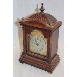 A German mantel clock with silvered and gilt arched dial in walnut and brass mounted case