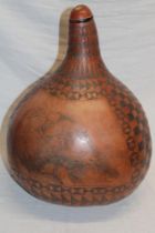 An unusual natural polished gourd etched with buffalo and eagle panels within geometric decoration,