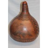 An unusual natural polished gourd etched with buffalo and eagle panels within geometric decoration,