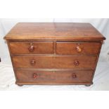 A small Victorian mahogany chest of two short and two long drawers with turned handles on turned